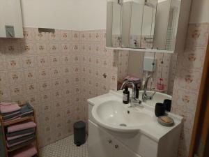 a bathroom with a sink and a mirror at Ferienwohnung Sander mit Innenpool in Möhnesee +7 photos