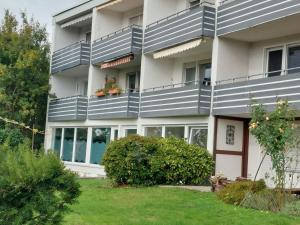 an apartment building with a blue and white facade at Ferienwohnung Sander mit Innenpool in Möhnesee