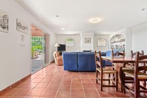 a dining room and living room with a table and chairs at Villa Lucio in La Londe-les-Maures