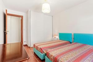 a bedroom with a blue bed in a room at Villa Lucio in La Londe-les-Maures +23 photos