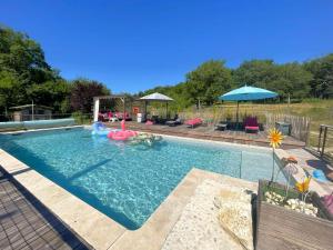 a large swimming pool with a inflatable at La Colombière in Salviac