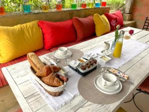 a table with a tray of bread and pastries on it at La Colombière in Salviac