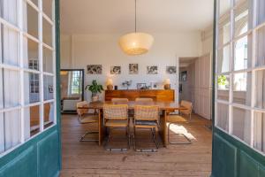 a dining room with a wooden table and chairs at Belle villa basque in Anglet