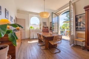 a kitchen and dining room with a wooden table and chairs at Belle villa basque in Anglet +14 photos