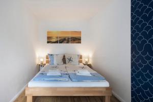 a bedroom with a bed with blue and white walls at Bungalow Schoner Greif, Bgl 8 in Dranske