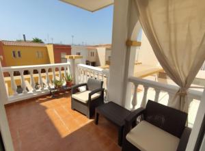 a balcony with two chairs and a railing at Cerca plaza de Toros Vera in Vera
