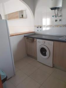 a small kitchen with a washing machine in it at Cerca plaza de Toros Vera in Vera +21 photos