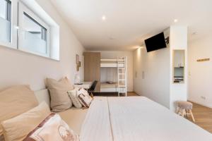 a bedroom with a large bed and a couch at Fewo Parkside S2 - 8Min Legoland in Günzburg