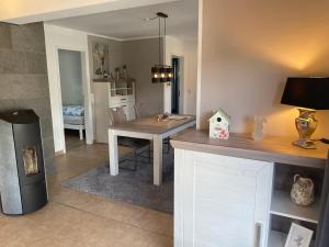 a kitchen with a table and a dining room at Glückshuuske Sauerland in Meschede +13 photos