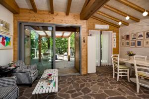 a living room with a door open to a patio at Roccafiore Wine Resort & Spa in Todi