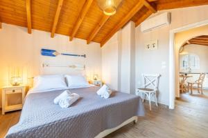 a bedroom with a bed with towels on it at Villa Konstantina Lulas Penthouse in Petrití