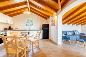 a kitchen and dining room with a table and chairs at Villa Konstantina Lulas Penthouse in Petrití