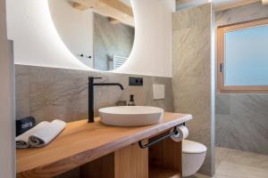 a bathroom with a sink and a mirror at Feichterhof in San Genesio Atesino +66 photos