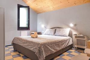 a bedroom with a large bed with a wooden ceiling at Cadepaia Lago Maggiore in Laveno-Mombello