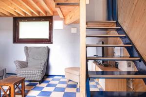 a staircase in a room with a chair and a table at Cadepaia Lago Maggiore in Laveno-Mombello