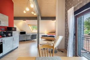 a kitchen and living room with a bed in the background at Elkes Ferienappartment in Eschenrod