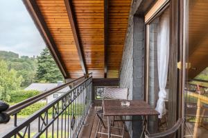 a balcony with a table and a window at Elkes Ferienappartment in Eschenrod