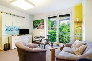 a living room with two couches and a tv at Ferienwohnung Refugium Nest in Sigmaringen