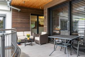 a patio with a table and chairs on a deck at Ferienwohnung Refugium Nest in Sigmaringen