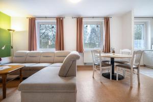 a living room with a couch and a table at Kolbatzer Mühle in Lychen