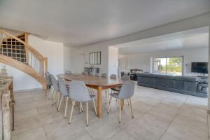 a dining room with a wooden table and chairs at Villa Virginie gite 2 in Faudoas