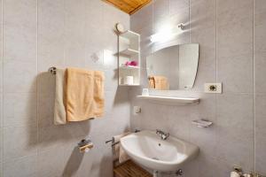 a white bathroom with a sink and a mirror at Bed and Breakfast Ederhof in San Giacomo +133 photos
