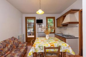 a kitchen with a table and a couch at La Sassetta in Bibbona +44 photos