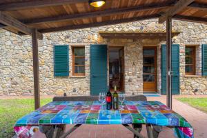 a table with bottles of wine on it in front of a house at La Sassetta in Bibbona