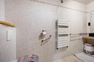 a bathroom with a toilet and a toilet paper dispenser at Chez Stephane et Estelle in Villarodin-Bourget +15 photos