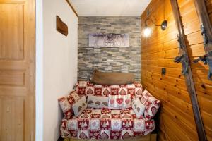 a bedroom with a bed and a brick wall at Chez Stephane et Estelle in Villarodin-Bourget