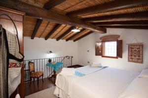 a bedroom with a bed and a table in a room at Sa Domedda in Orosei
