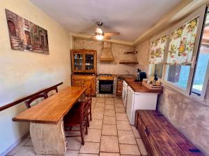 a kitchen with a wooden table and a counter at Volpe in Pitigliano
