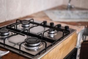 a stove top with four burners on a counter at Volpe in Pitigliano