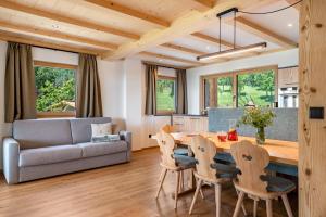 a kitchen and living room with a wooden table and chairs at Feichterhof in San Genesio Atesino