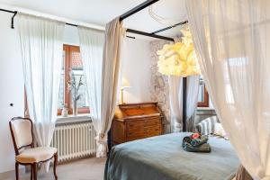 a bedroom with a bed and a dresser and a window at Schwarzwald Glück in Bühl