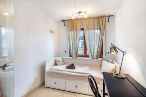 a bedroom with a bed with a desk and a mirror at Schwarzwald Glück in Bühl +59 photos