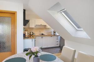 a kitchen with a table with a vase of flowers at Ferienwohnung Kleinbreitenbach 2 in Plaue