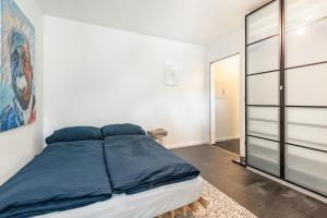 a bedroom with a bed in a white room at Schlossblick in Egloffstein