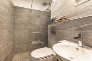 a bathroom with a white toilet and a sink at Schlossblick in Egloffstein +16 photos
