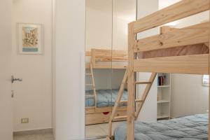 a bunk bed in a room with a mirror at Sunset Dimora in Siculiana Marina
