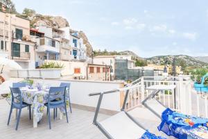 a balcony with a table and chairs and a view at Sunset Dimora in Siculiana Marina