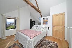 a bedroom with a bed and a window at La maison Poulogne in Capvern