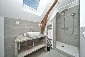 a bathroom with a sink and a shower at La maison Poulogne in Capvern +22 photos