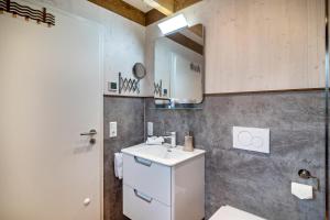 a bathroom with a sink and a mirror at Vroni in Ebersbach-Musbach +26 photos