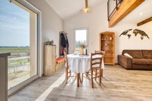 a living room with a table and chairs and a couch at Le Refuge des Vignes in Lamonzie-Saint-Martin +14 photos