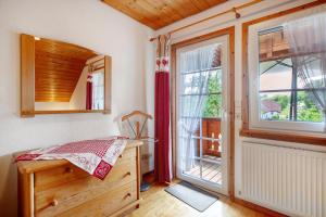 a bedroom with a desk and a large window at Haus Schlageter in Dachsberg im Schwarzwald