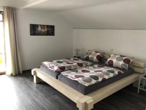 a bedroom with a large bed with pillows on it at Haus Peschl Fewo 2 in Neureichenau