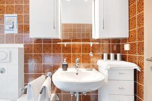 a bathroom with a sink and a toilet at Haus Erna am Deister in Barsinghausen +17 photos