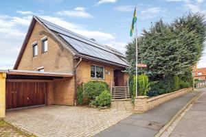 a brick house with a flag in front of it at Haus Erna am Deister in Barsinghausen