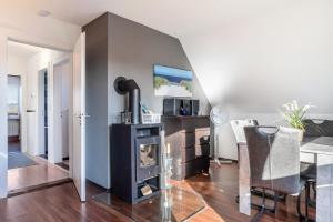 a living room with a fireplace and a table at Ferienwohnung Moin in Schönwalde am Bungsberg